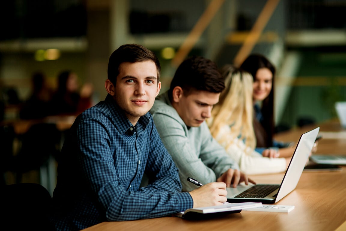 College Students with Laptop Studying in the School Library